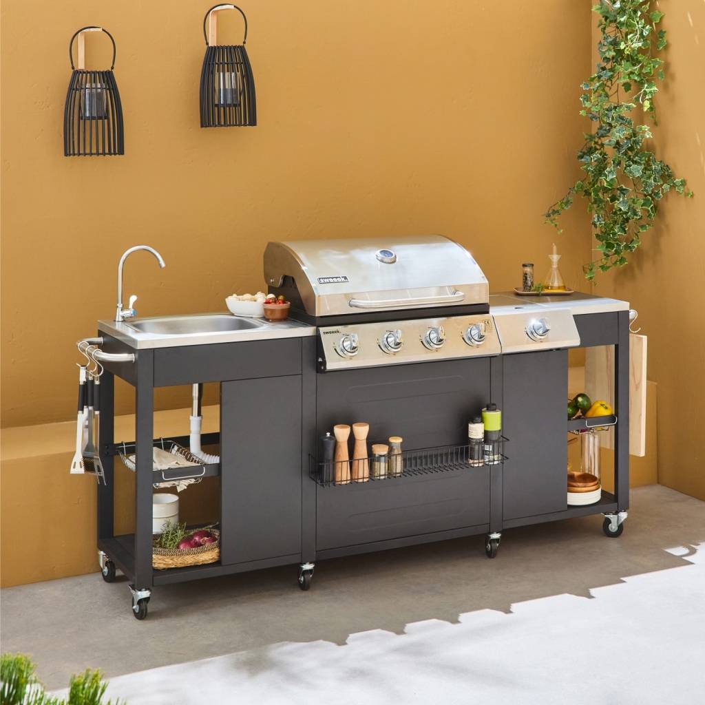 sweeek - Barbecue. cuisine extérieure gaz - D'Artagnan - Barbecue 5 brûleurs dont 1 feu latéral. inox et noir. évier. planche à découper bois. | sweeek - Image 1